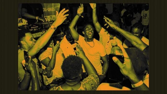AD_crowd_header.jpeg A group of people dance enthusiastically in a crowded room, many with their hands raised, as African music pulses through the speakers. The image, reminiscent of a vivid DJ Mag cover, has a yellow tint.