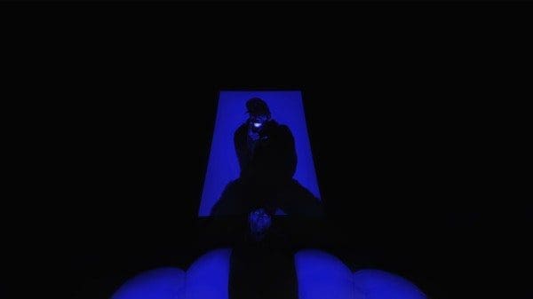 Vigro-Deep-My-House-My-Rules.jpeg A person sits under a blue light in an otherwise dark scene, creating a moody atmosphere with high contrast, reminiscent of the album cover artwork for Vigro Deep.