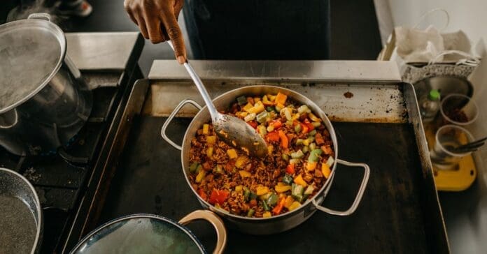 A chef is preparing food on a stove. A chef is preparing food on a stove.