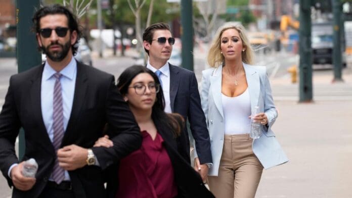 wirestory_e746294183467d0ebe540865e687dd30_16x9_992.jpg Four individuals dressed in business attire are walking outdoors on a city street. Two are holding water bottles, possibly discussing their next African safari adventure. The group includes three men and one woman.