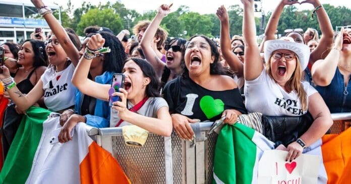 A crowd delighting at a music festival with late arrivals on day 3. A crowd delighting at a music festival with late arrivals on day 3.