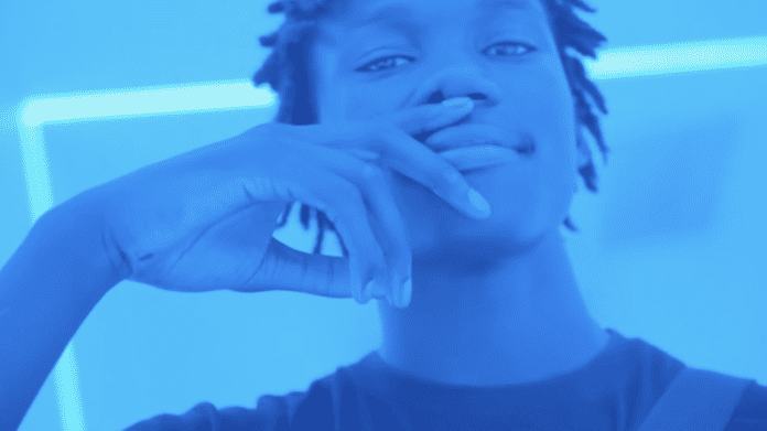A young man with dreadlocks is making a gesture with his finger during an interview. A young man with dreadlocks is making a gesture with his finger during an interview.