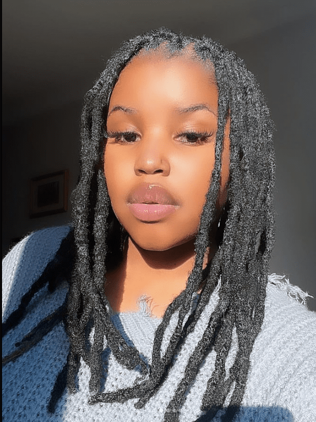 A woman with long dreadlocks posing for a photo featured in Springs Advertiser. A woman with long dreadlocks posing for a photo featured in Springs Advertiser.