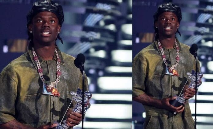 A man winning an Afrobeats award at the MTV Music Awards. A man winning an Afrobeats award at the MTV Music Awards.