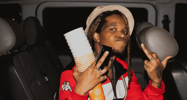 A Saudi man in a car holding two cups, explaining why he never desired to become a rap sensation. A Saudi man in a car holding two cups, explaining why he never desired to become a rap sensation.