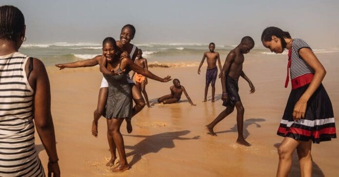 A youthful group enjoying a playful time on the sandy African beach. A youthful group enjoying a playful time on the sandy African beach.
