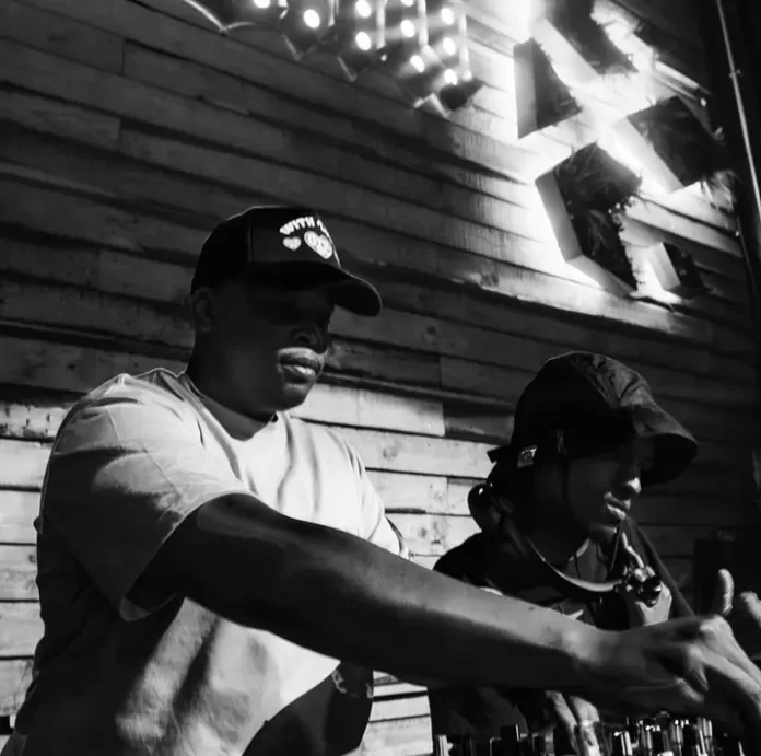 Two DJs shine on in a black and white photo. Two DJs shine on in a black and white photo.