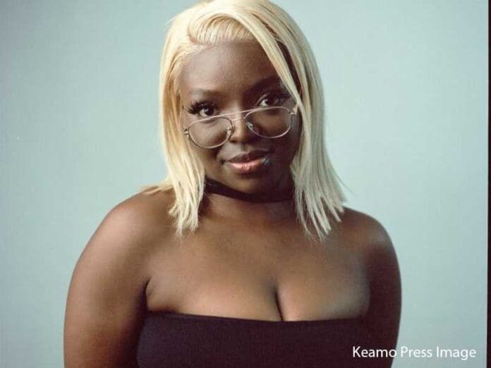 A black woman with glasses posing for a photo at an Amapiano DJ Lowa event. A black woman with glasses posing for a photo at an Amapiano DJ Lowa event.
