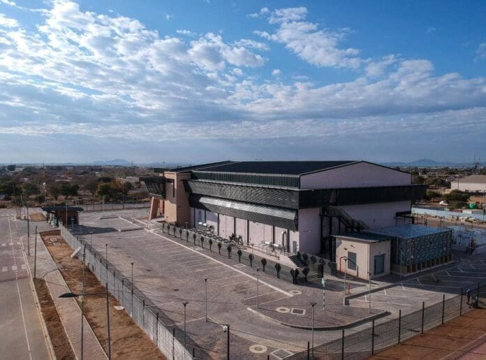 An aerial view of a building fenced off in the background. An aerial view of a building fenced off in the background.