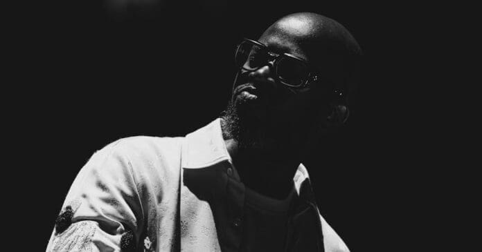 A black and white photo of a man in sunglasses, taken in South Africa. A black and white photo of a man in sunglasses, taken in South Africa.