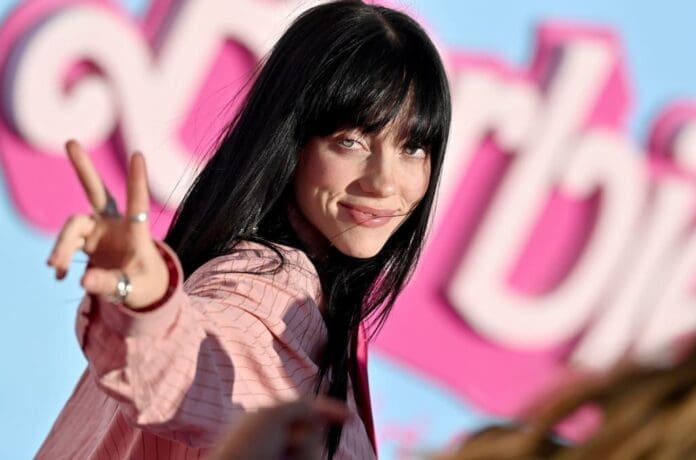 A woman with long black hair is making a peace sign similar to Billie Eilish. A woman with long black hair is making a peace sign similar to Billie Eilish.