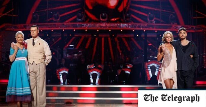 A live group of people standing on a stage in front of an audience for the Strictly Come Dancing week 7 results. A live group of people standing on a stage in front of an audience for the Strictly Come Dancing week 7 results.