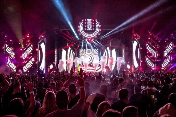 A stacked line-up of people at an Ultra South Africa music festival at night. A stacked line-up of people at an Ultra South Africa music festival at night.