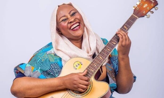 A woman is smiling while playing an acoustic guitar at the SAMAs. A woman is smiling while playing an acoustic guitar at the SAMAs.