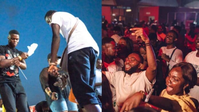 Properly Detty, a group of people are at a concert and one is holding a microphone. Properly Detty, a group of people are at a concert and one is holding a microphone.