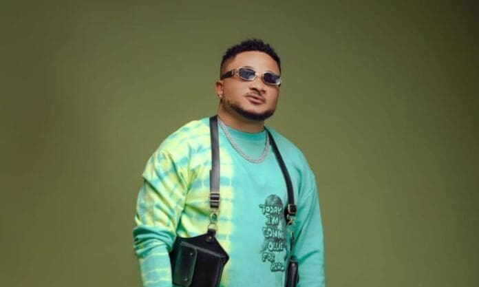 A man wearing sunglasses and a tie-dye shirt attends a music academy in Nigeria. A man wearing sunglasses and a tie-dye shirt attends a music academy in Nigeria.