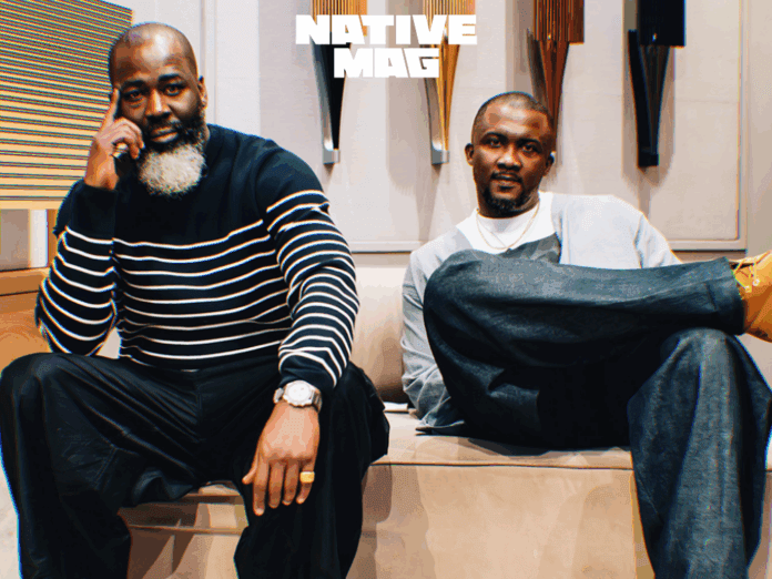 Two men pose on a bench indoors; one in a striped sweater with a beard, the other in a light jacket. The "NativeMag" logo is above them, highlighting their connection to African Art and culture.