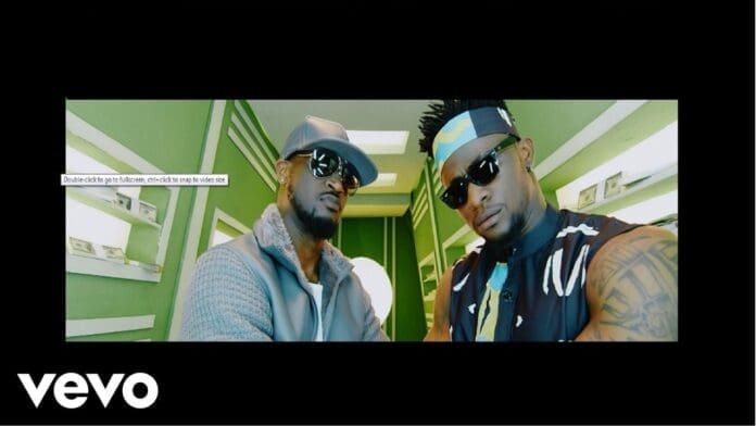 Two men, Selebobo and Mr. P, wearing sunglasses and stylish outfits stand side by side in a brightly lit, green and white room with dollar bills on the walls. The Vevo logo is visible in the bottom left corner.