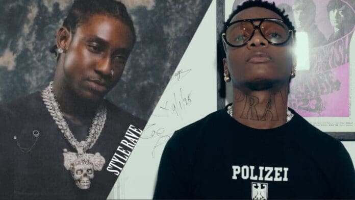 Two individuals pose side by side; one sports a large chain necklace and dark shirt, while the other, rocking a "POLIZEI" shirt and "PRAY" neck tattoo, discusses trending songs by Shallipopi and Wizkid.