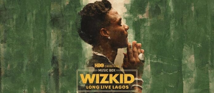 A person stands in profile with hands clasped in front of a green textured background. Text reads: "HBO documentary Music Box Wizkid: Long Live Lagos.
