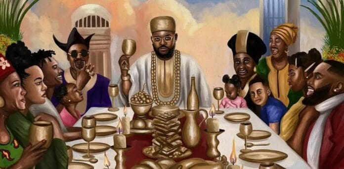 A group of people sit around a table set with gold dishes, food, and goblets, as a Nigerian star in the center wearing a crown and jewelry raises a cup in celebration.