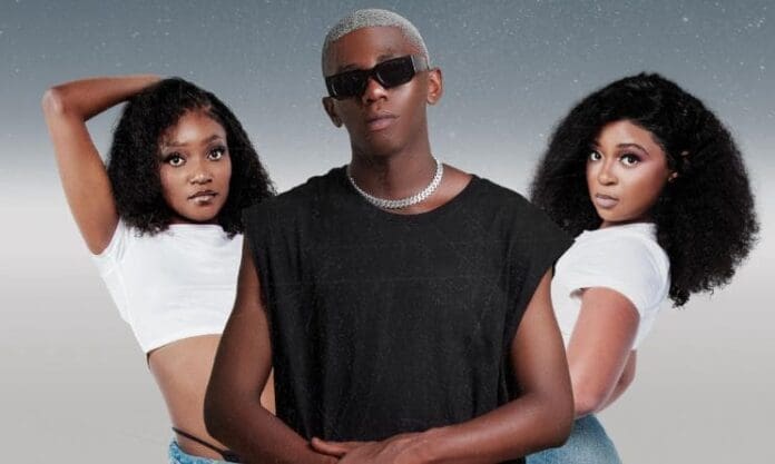 Three people pose against a gradient background. The man in the center, rumored to be an Amapiano producer for Officixl RSA’s Sony deal, wears sunglasses and black, flanked by two women in white tops, both with curly hair.