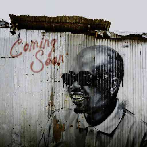 A mural of a man wearing sunglasses is painted on a corrugated metal wall with "Coming Soon EP" written in red above him, giving a nod to Sam Deep and Zuma.