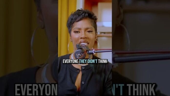 A woman speaking into a microphone, with the caption "EVERYONE THEY DIDN'T THINK" displayed across the center—channeling the bold energy of Afrobeats and icons like Tiwa Savage.