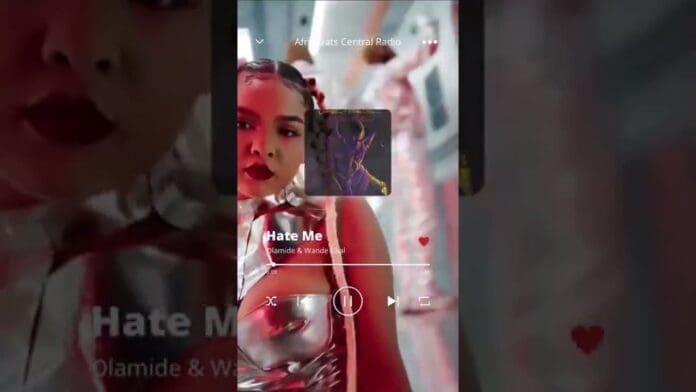 A music player interface displays "Hate Me" by Olamide & Wande Coal, highlighting trending Afrobeats songs, with a woman in metallic clothing shown in the background.
