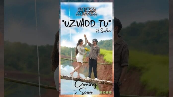 A man and woman stand facing each other on a wooden bridge, holding hands. The poster text reads: "Savio Marak 'Uzvadd Tu' ft. Sofia. Konkani love song. Coming 2025." A bouquet is in the woman's hand.