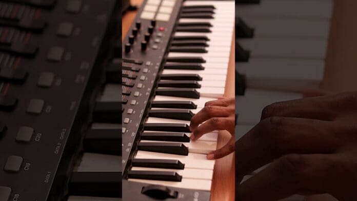 A person plays a digital keyboard, their right hand pressing the keys and control buttons on the left side—perfect for creating an Amapiano Type Beat or exploring new Instrumental 2026 sounds.