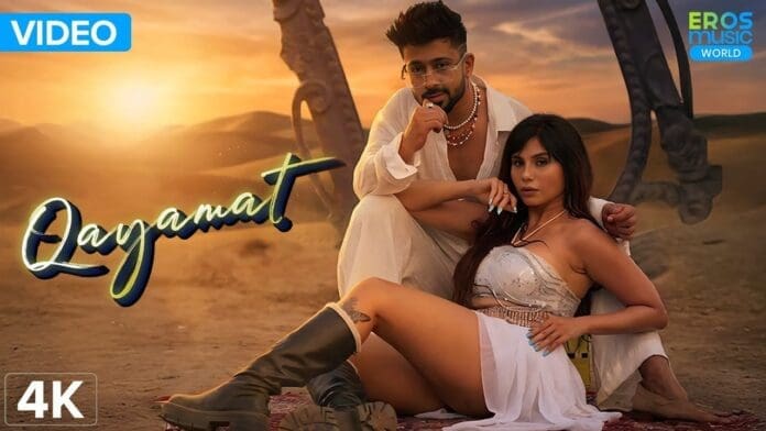 A man and woman pose in stylish outfits in a desert setting at sunset, with "Qayamat" and Eros Music World branding featured on the image.
