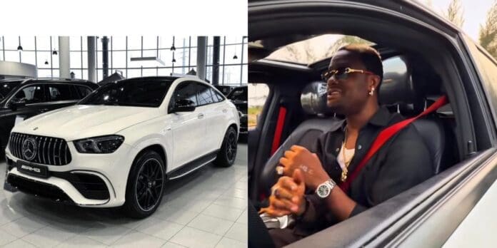A white 2022 Mercedes-Benz GLE 53 AMG SUV, valued at ₦160 million, shines in a showroom beside a person wearing sunglasses and jewelry, seated inside with a red seatbelt.