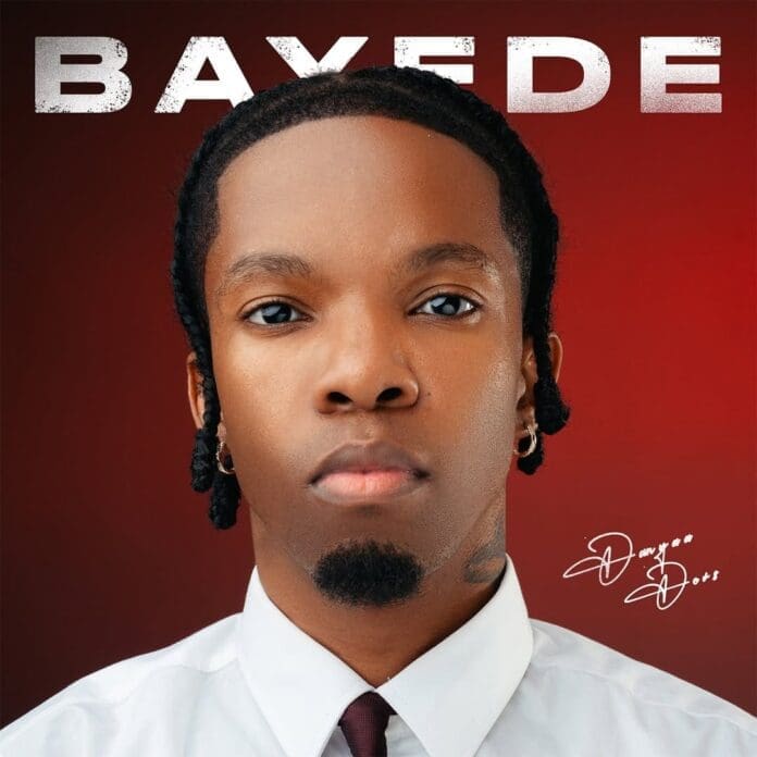 A man with braided hair, wearing a white shirt and tie, poses against a red background with "BAYEDE" above—an image celebrating Danya Devs and his debut solo album, with a signature at the bottom right.