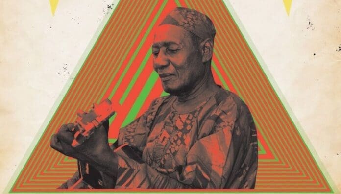 An elderly man in traditional clothing plays a stringed instrument against a background of concentric green and red triangles, evoking the vibrant musical storytelling of Ebo Taylor featured on OkayAfrica.