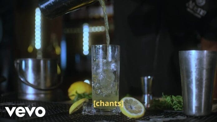 A metal shaker pours liquid into a tall glass with ice, surrounded by lemon slices, herbs, and bar tools on a dimly lit counter. The word "chants" and “Official Lyric Video” appear in yellow captions.