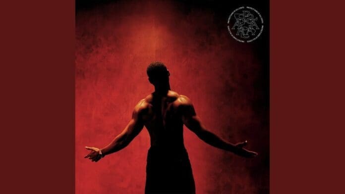 A shirtless person stands with their back to the camera, arms outstretched, against a red background. The word "Mademoiselle" appears in circular text in the top right corner.