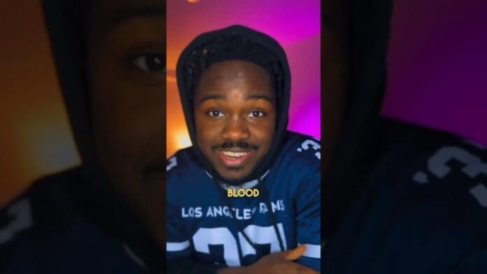 A person wearing a dark hoodie and a Los Angeles Rams shirt sits indoors, smiling at the camera with the word "BLOOD" in yellow text overlaid on the image, capturing a vibe as stylish as top fashion brands or trending Afrobeat songs.