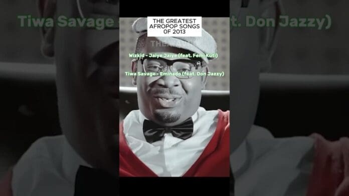 A man wearing glasses, a gray hat, red bow tie, and white shirt appears behind a list titled "The Greatest Afrobeats Songs of 2013," featuring Wizkid and Tiwa Savage.
