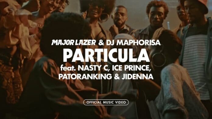 A group of people gather and pose together at a party; text over image promotes the Particula music video by Major Lazer & DJ Maphorisa featuring Nasty C, Ice Prince, Patoranking, and Jidenna.