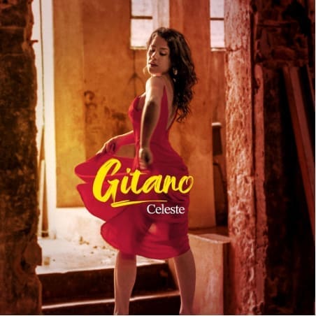 A woman in a red dress performs a Flamenco dance in a rustic, sunlit setting, with the words "Gitano" and "Celeste" displayed in yellow and white text.