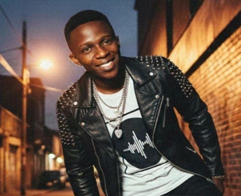 A man in a leather jacket, inspired by Afrobeats, carries himself with cool confidence and the wisdom of life's lessons.