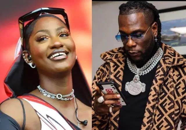 Two stylishly dressed individuals: one smiling woman wearing sunglasses and jewelry, and one man with glasses, jewelry, and a patterned jacket looking at his phone—both exuding the bold flair of global music icons like Tems and Burna Boy.