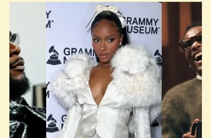 At a Grammys 2026 event at the Grammy Museum, Tyla stuns in a white fur-trimmed outfit, posing between two men—one in sunglasses and the other laughing in a sweater—celebrating her Best African Music Performance nomination.