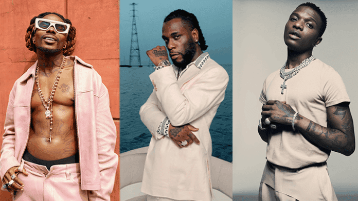 Untitled-1-1945.png Three men pose separately for portraits: the first in a pink outfit with sunglasses, channeling Burna Boy vibes; the second in a white suit near water; and the third in a beige outfit against a plain background, ready for Afro Nation festival.