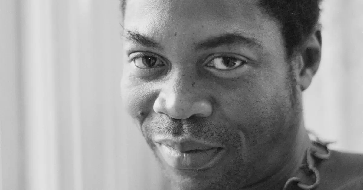 Black and white close-up of a person with short hair, looking directly at the camera with a neutral expression—a style reminiscent of portraits seen in Semafor’s features.