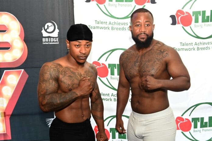 Two muscular men with tattoos pose shirtless at a boxing event, capturing the essence of the Trending Awards. One wears black shorts and a durag, while the other sports light-colored shorts. Event banners showcasing DBN Gogo and Uncle Waffles are visible in the background.