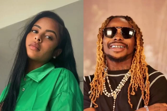 A woman with long black hair wearing a green shirt, reminiscent of Alexis Skyy, is on the left, and a man who could be mistaken for Asake with his blonde dreadlocks, sunglasses, and black shirt adorned with necklaces is on the right.