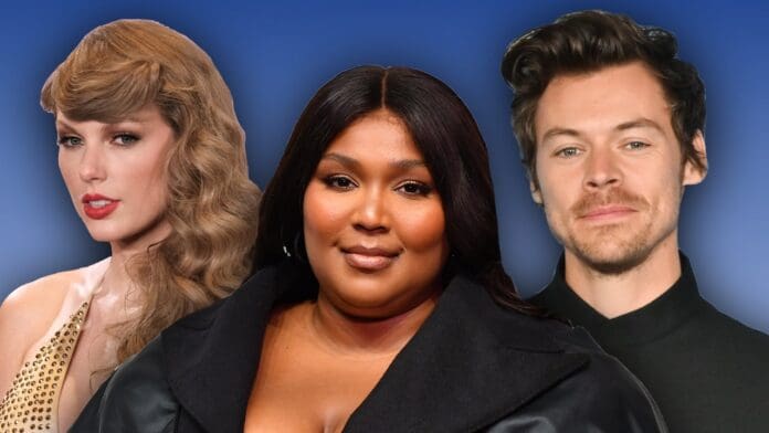 Three individuals are pictured in front of a blue background. The person on the left, resembling Taylor Swift with long, wavy blonde hair, stands beside the center figure with long, straight dark hair. On the right, someone sporting short, wavy hair completes this snapshot from the 2023 iHeartRadio Music Awards.