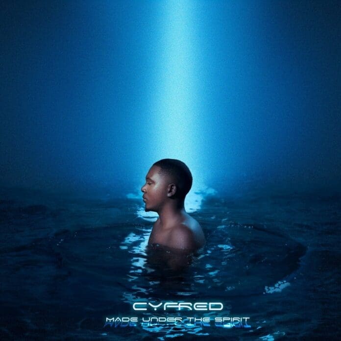 A man illuminated by a blue light in the water.